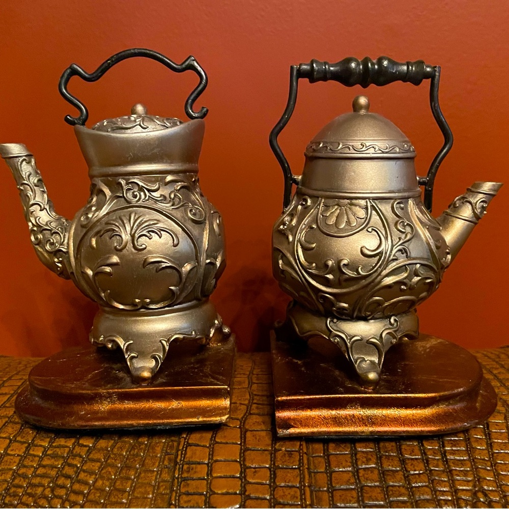 Adorable tea pot book ends.  5” high. Sturdy. Ornate and silver in color.